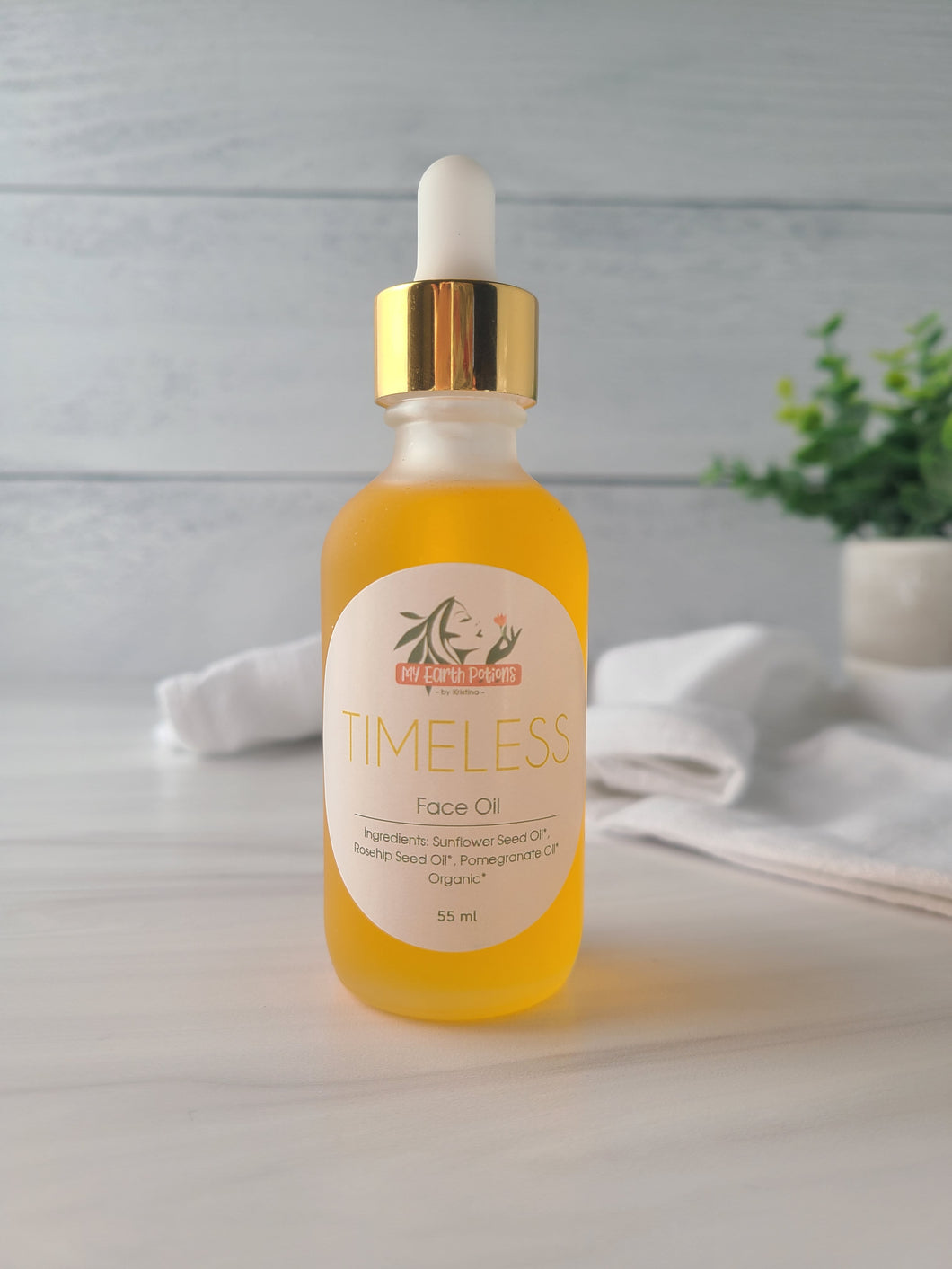 anti-aging face oil in 2 oz glass bottle