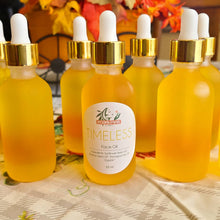 Charger l&#39;image dans la galerie, multiple golden anti-aging face oil 2 oz bottles in front of fall décor 
