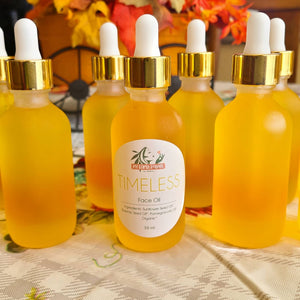 multiple golden anti-aging face oil 2 oz bottles in front of fall décor 